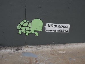 "No grievance deserves violence" graffito