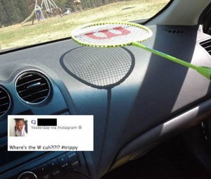 Badminton racket with a "W" painted on the strings, held over a car's dashboard. The badminton strings cast a shadow, but not the "W". Inset is a Tweet: "Where the W, cuh? #Trippy"