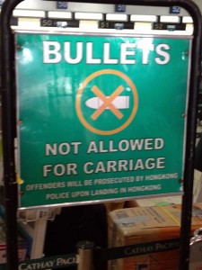 Sign: "Bullets not allowed for carriage / Offenders will be prosecuted by Hongkong police upon landing in Hongkong"