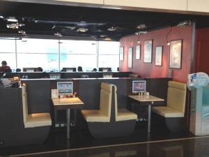 Tables with TV screens at Beef Noodle restaurant in Hong Kong airport
