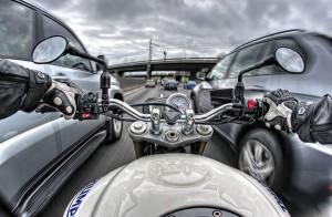 High dynamic range point-of-view shot of a motorbike ride down a busy highway