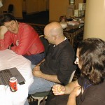 Nelson Minar, Clay Shirky, Wes Felter in conversation at a conference table.