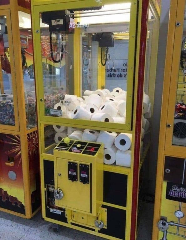 “Claw” arcade machine filled with toilet paper rolls instead of the typical prizes.