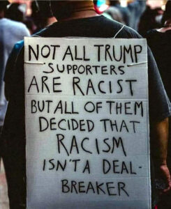 Photo: Man wearing “sandwich board” sign that reads “Not all Trump supporters are racist, but all of them decided that racism isn’t a deal-breaker”.
