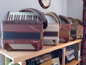 Photo: A row of Alessandrini Celt accordions in various wood finishes.