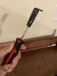 Photo: Allen key duct taped to a screwdriver, in my hand.