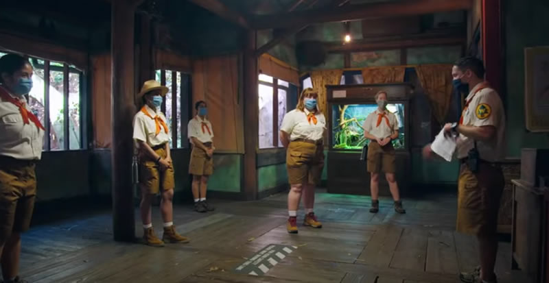 Photo: The staff of the Enchanted Tiki Room, all in surgical masks, being briefed.