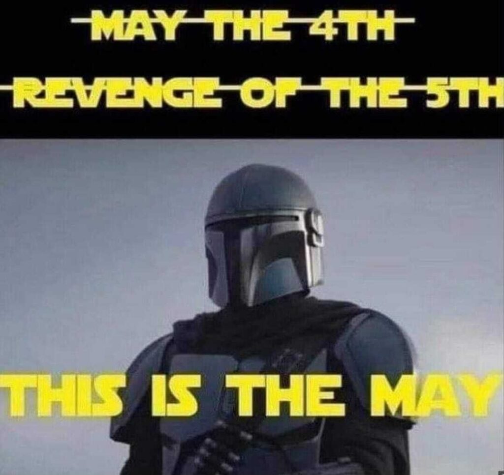 Picture of Din Djarin (“The Mandalorian”) with the struck-out headings “May the 4th” and “Revenge of the 5th”, and below them, the final heading: “THIS IS THE MAY”