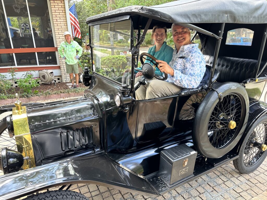 Anitra Pavka and Joey deVilla in a 1916 Ford Model T, seen from the car’s left side.