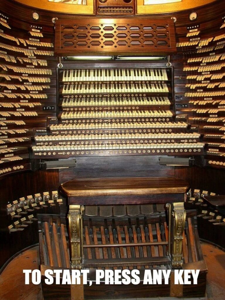 Photo of pipe organ with 7 keyboards and a LOT of pedals and switches.